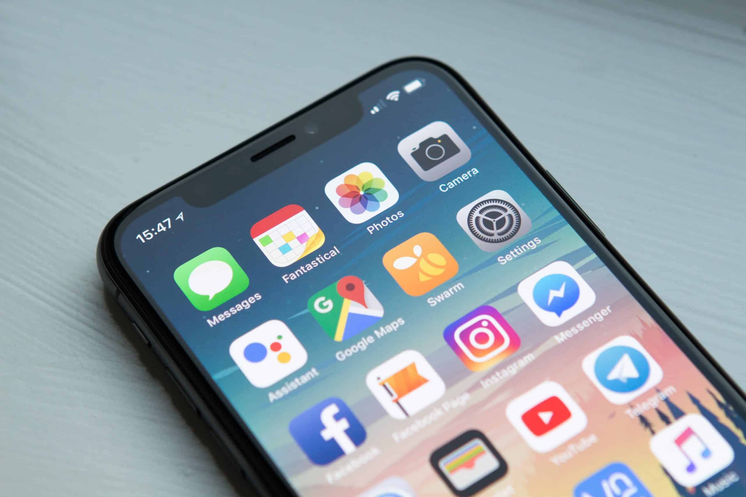 stock photo of smartphone resting on a table with home screen on